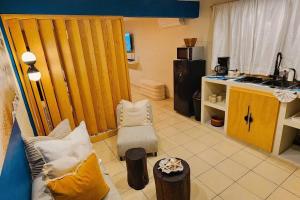 a living room with a couch and a kitchen at Santorini Suites Cozumel in Cozumel