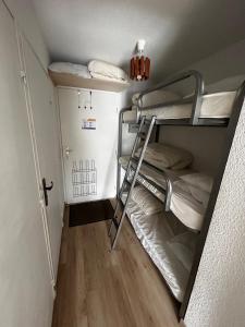 a small room with two bunk beds and a ladder at Studio Risoul 1850 in Risoul