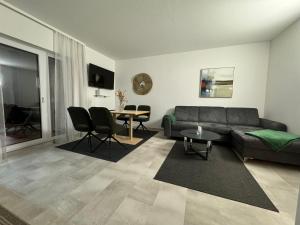 a living room with a couch and a table at Apartments Villach in Villach