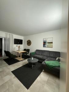a living room with a couch and a table at Apartments Villach in Villach +4 photos