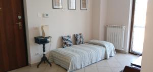a bedroom with a bed and a tv on the wall at Appartamento Ameria in Amelia