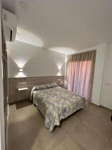 Postel nebo postele na pokoji v ubytování RAQUEL'S - Habitacions i Apartaments turístics -