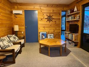 a living room with a couch and a coffee table at Picturesque Waikawa - Picton Holiday Home in Picton