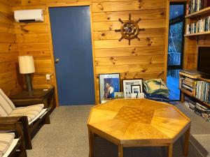 a living room with a chess board on a table at Picturesque Waikawa - Picton Holiday Home in Picton +15 photos
