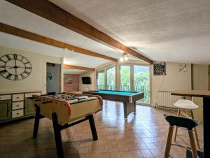 a room with a pool table and a piano at LE VERTBRUCHE - Gîte avec superbe vue pour 15 pers in La Bresse