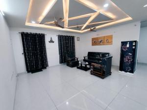 a living room with a coffered ceiling and a white floor at Skyline View Suite in Hyderabad