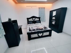 a bedroom with a black bed and a mirror at Skyline View Suite in Hyderabad