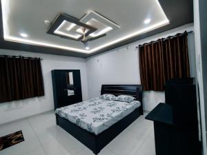 a bedroom with a bed and a ceiling at Skyline View Suite in Hyderabad
