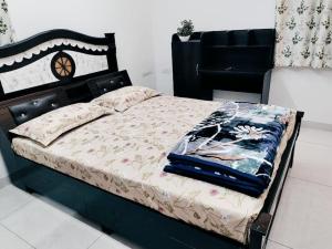 a bedroom with a bed with a black bed frame at Skyline View Suite in Hyderabad