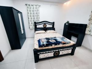 a bedroom with a bed with a black bed frame at Skyline View Suite in Hyderabad