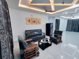 a living room with two chairs and a table at Skyline View Suite in Hyderabad