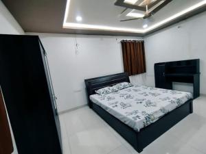 a bedroom with a bed and a table in it at Skyline View Suite in Hyderabad