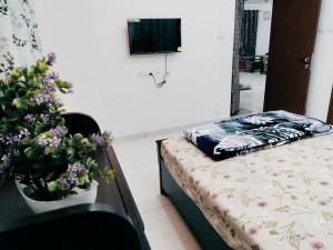 a bedroom with a bed and a table with flowers at Skyline View Suite in Hyderabad