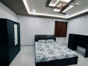 a bedroom with a bed and a ceiling fan at Skyline View Suite in Hyderabad