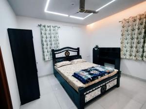 a bedroom with a black bed in a room at Skyline View Suite in Hyderabad
