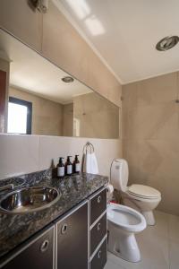a bathroom with a sink and a toilet at Complejo Solares in Alta Gracia