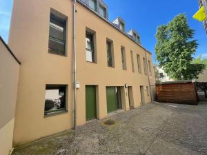 Beste Lage - TOP-Apartment - Leipzig Hotspot No1 في لايبزيغ: مبنى ذو أبواب خضراء وبوابة خشبية