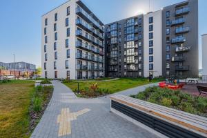 a walkway in front of a building with a cross on it at Two room Apartment - self check-in in Vilnius