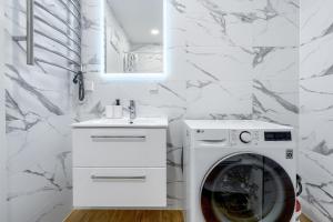 a white laundry room with a washer and dryer at Two room Apartment - self check-in in Vilnius