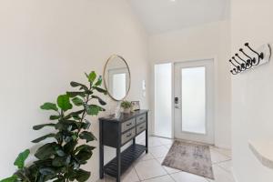 a bathroom with a black dresser and a mirror at Fantastic Weekly Rental Pool Home in Falcons Glen of Lely - Naples, Florida! in Naples