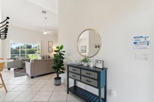 a living room with a mirror and a table at Fantastic Weekly Rental Pool Home in Falcons Glen of Lely - Naples, Florida! in Naples +30 photos