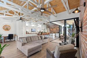 an open living room with a couch and a table at Swim-Through Glass Pool Villa, 5min Beach in Playa Flamingo