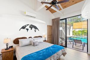 a bedroom with a bed and a swimming pool at Swim-Through Glass Pool Villa, 5min Beach in Playa Flamingo