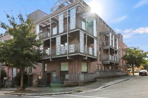 an apartment building with balconies on a street at Sleek Modern City Apartment in Milton Keynes