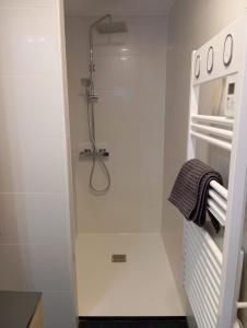 a walk in shower in a white bathroom at Loft pays basque in Anglet