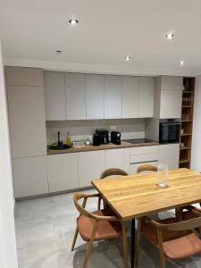a kitchen with a wooden table and some chairs at Cetinje Holiday Home for Family in Cetinje