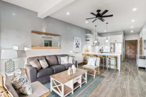 a living room with a couch and a table at Charming 2BR - 2BA Condo Steps to the Beach in Tamarindo