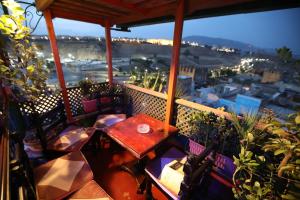 a balcony with a table and a view of a city at Dar Belmamoun in Fez
