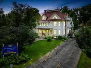 a large house with a sign in front of it at Marmora and Lake Inn and Victorian Diner - Grand Victorian Suites- Level 2 in Marmora