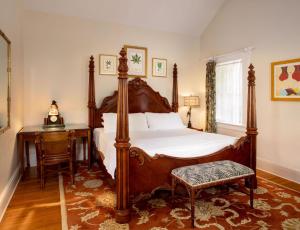 a bedroom with a large bed and a table at The Gardens Hotel in Key West