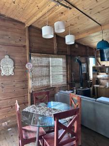 a dining room with a table and chairs at LA VECINDAD in Dique Luján