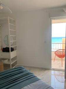 a bedroom with a bed and a view of the ocean at Beach Penthouse in Torrevieja