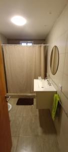 a bathroom with a sink and a mirror at Quincho Monoambiente Con Parrilla in Balcarce