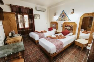 Postel nebo postele na pokoji v ubytování Nefertiti Hotel Luxor
