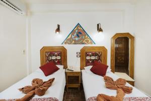 Postel nebo postele na pokoji v ubytování Nefertiti Hotel Luxor