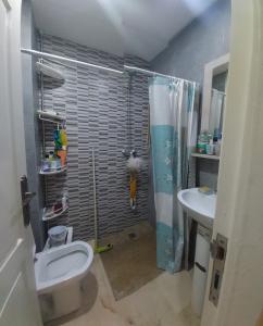 a bathroom with a shower and a toilet and a sink at Goulmim in Mohammedia