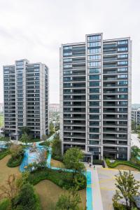 two tall buildings in a city with a park at 在盐官民宿 in Hsü-chia-ch'iao