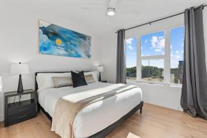 a bedroom with a bed and a large window at Superb NEW 2BR amazing amenities in Salt Lake City