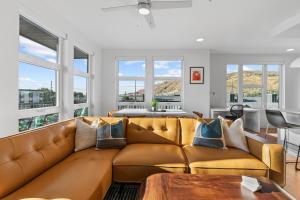 a living room with a large brown leather couch at Superb NEW 2BR amazing amenities in Salt Lake City +101 photos