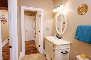 a bathroom with a sink and a mirror at Decatur Sugar Mill Blues in New Orleans +47 photos