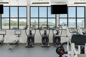 a gym with cardio equipment in a room with windows at Superb NEW 2BR amazing amenities in Salt Lake City