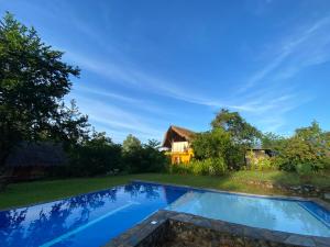 a swimming pool in front of a house at Butanding Barrio Villa in Puerto Princesa City