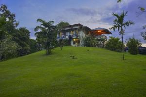 a house on top of a grassy hill at Casa Drake Lodge in Drake