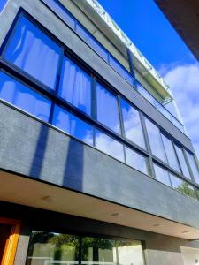 an image of a house with glass windows at Beach House Delegado Marcio in Balneário Camboriú