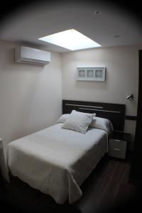 Postel nebo postele na pokoji v ubytování Hostal Extremeño