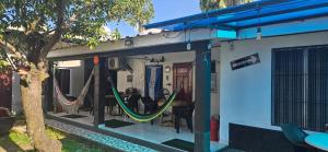 a house with hammocks on the outside of it at Aguacate in San Pedro Sula